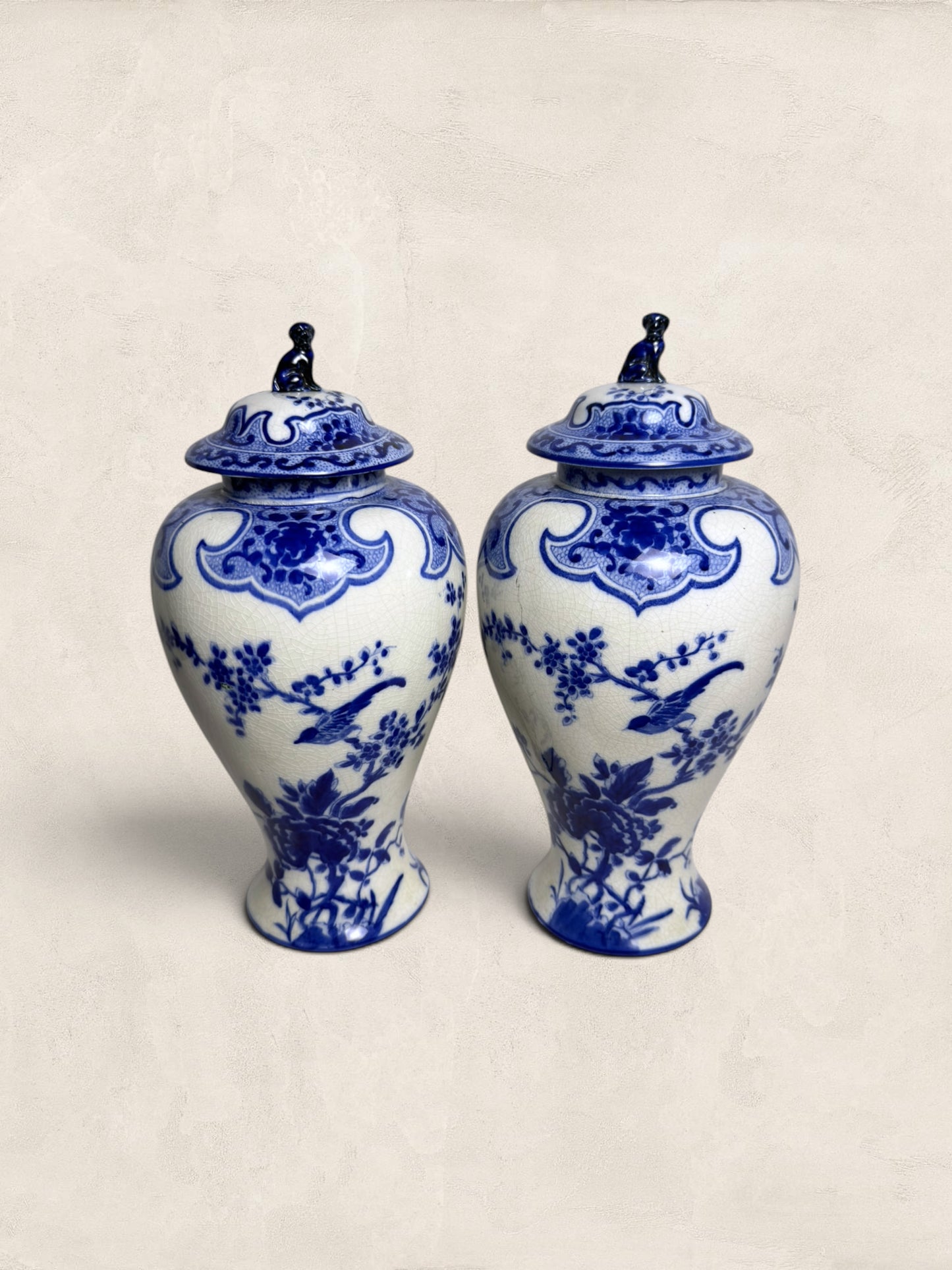 Pair of Blue & White Crackle Glazed Covered Urns with Bird Finials