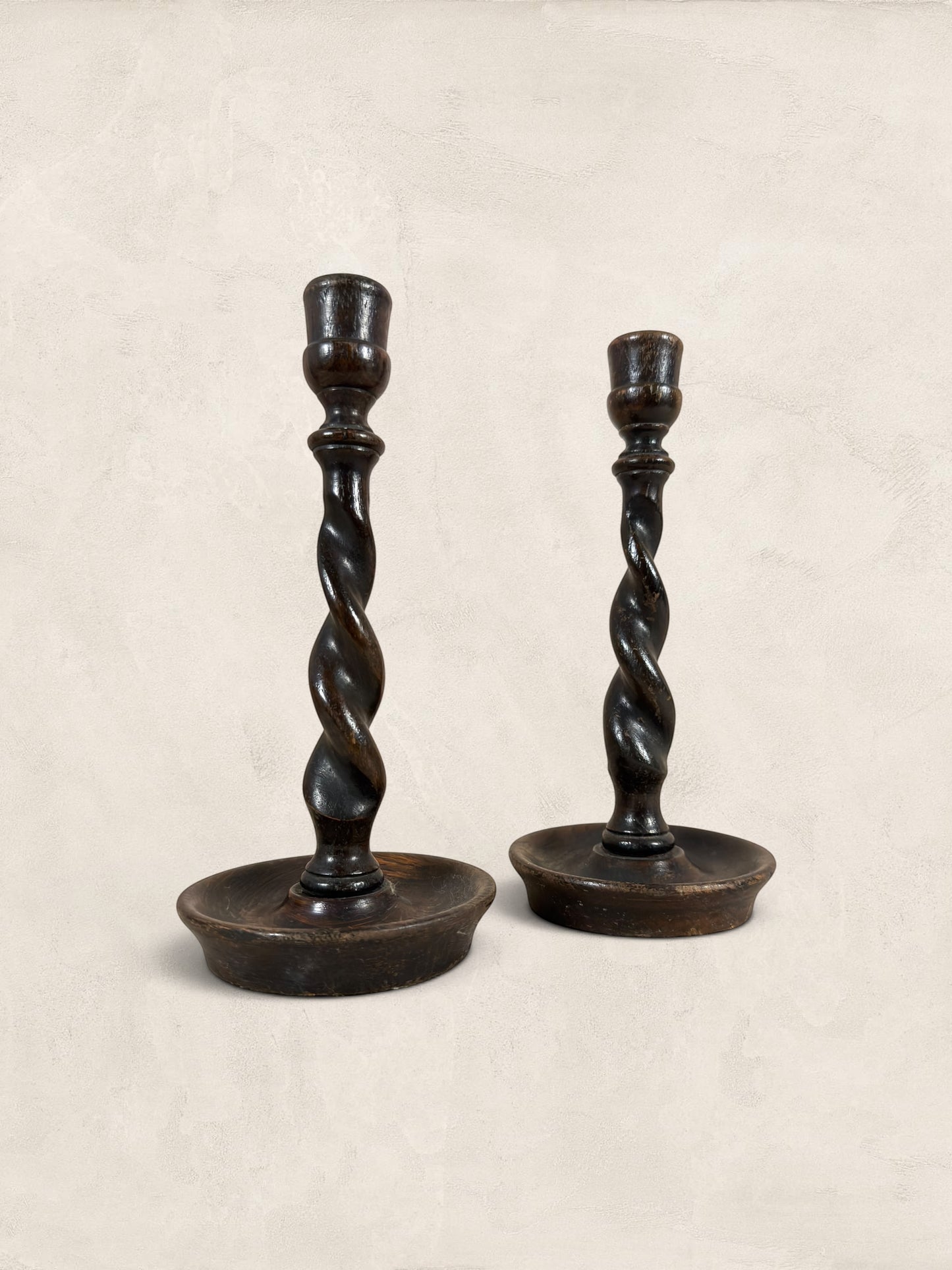 Stone and Relic antique dark oak barley twist candlestick holders, set of 2, circa 1910. Hand-carved spiral stems and circular bases.