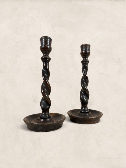 Stone and Relic antique dark oak barley twist candlestick holders, set of 2, circa 1910. Hand-carved spiral stems and circular bases.
