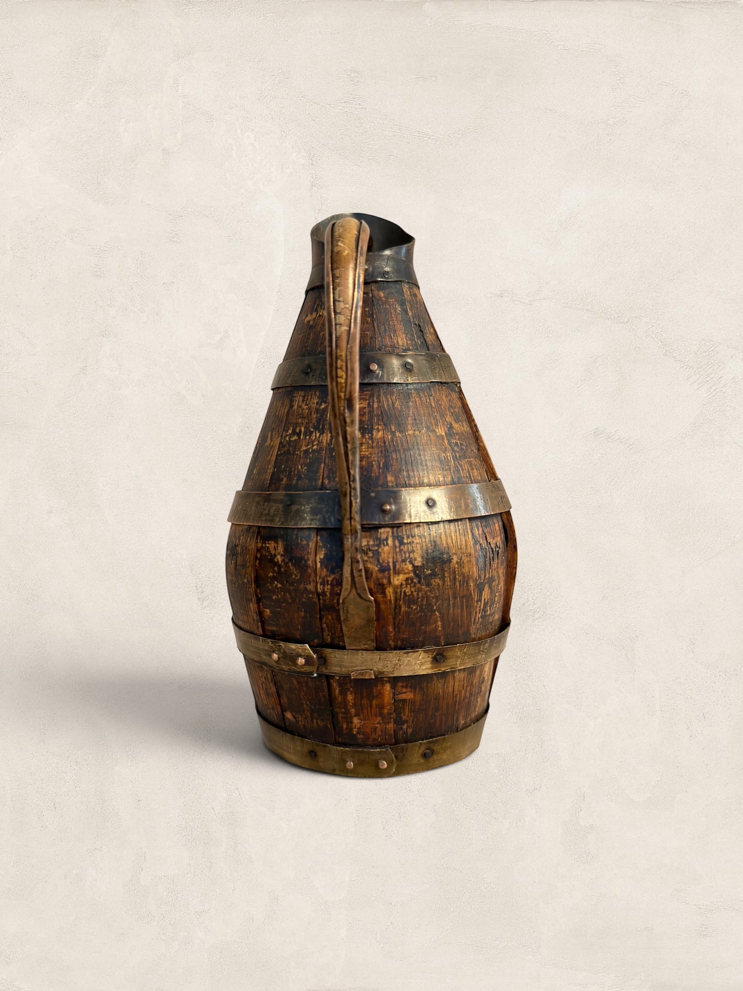 Antique French barrel-shaped cider/wine jug from Stone and Relic, made of staved oak with copper banding and forged metal handle. Decorative use only.