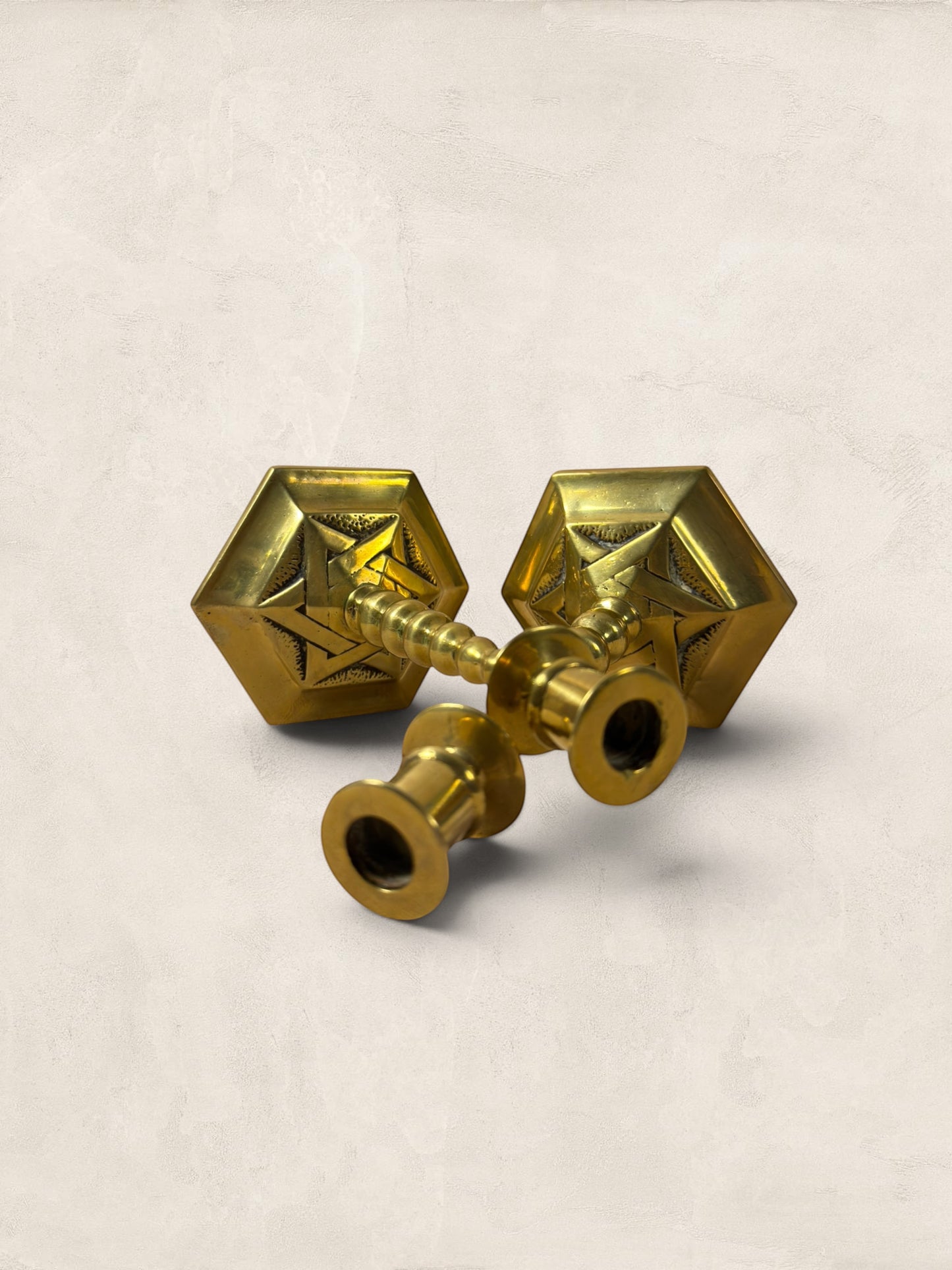 Stone and Relic pair of vintage brass hexagonal base candlesticks with aged patina and decorative etching.