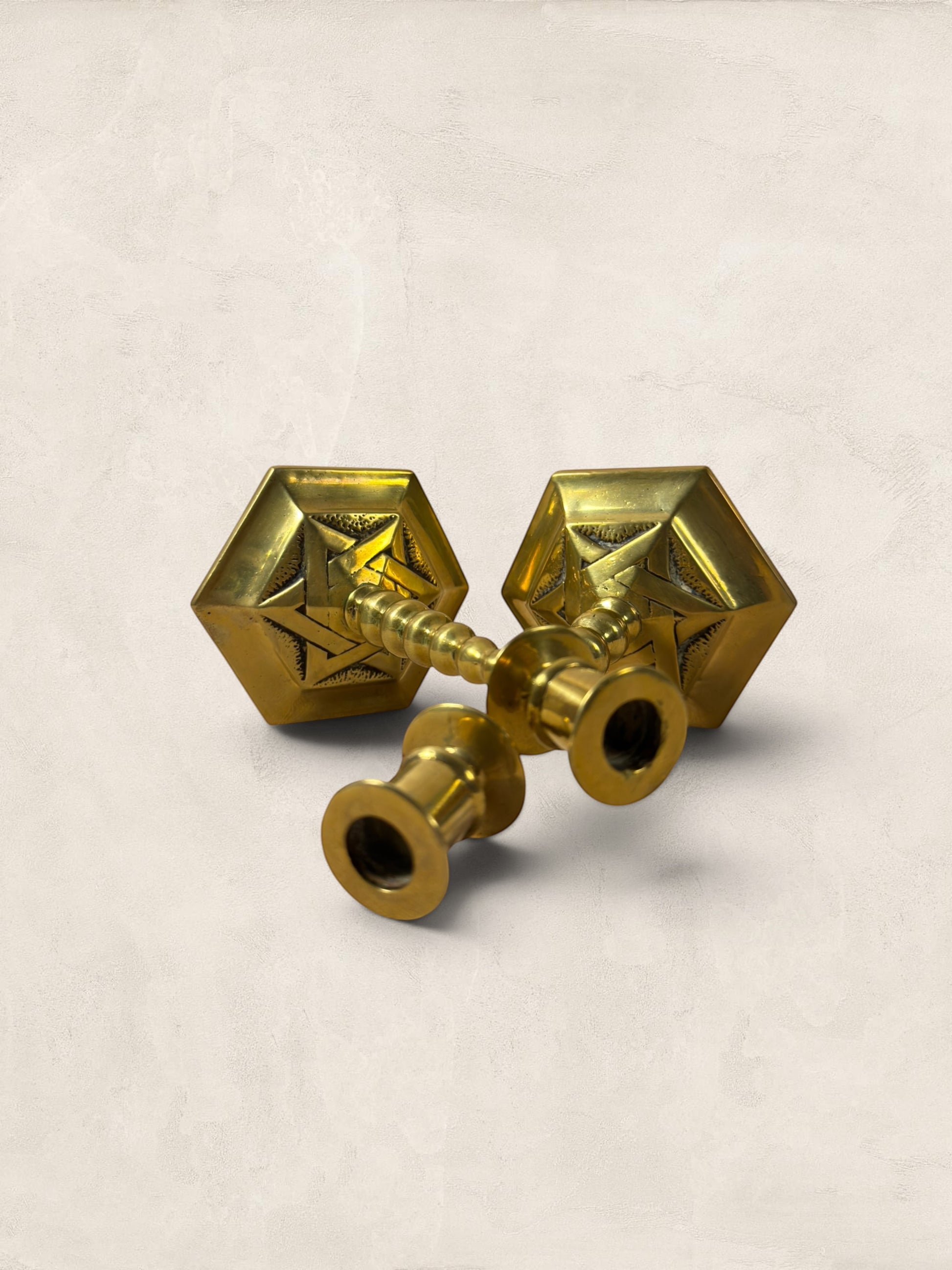 Stone and Relic pair of vintage brass hexagonal base candlesticks with aged patina and decorative etching.