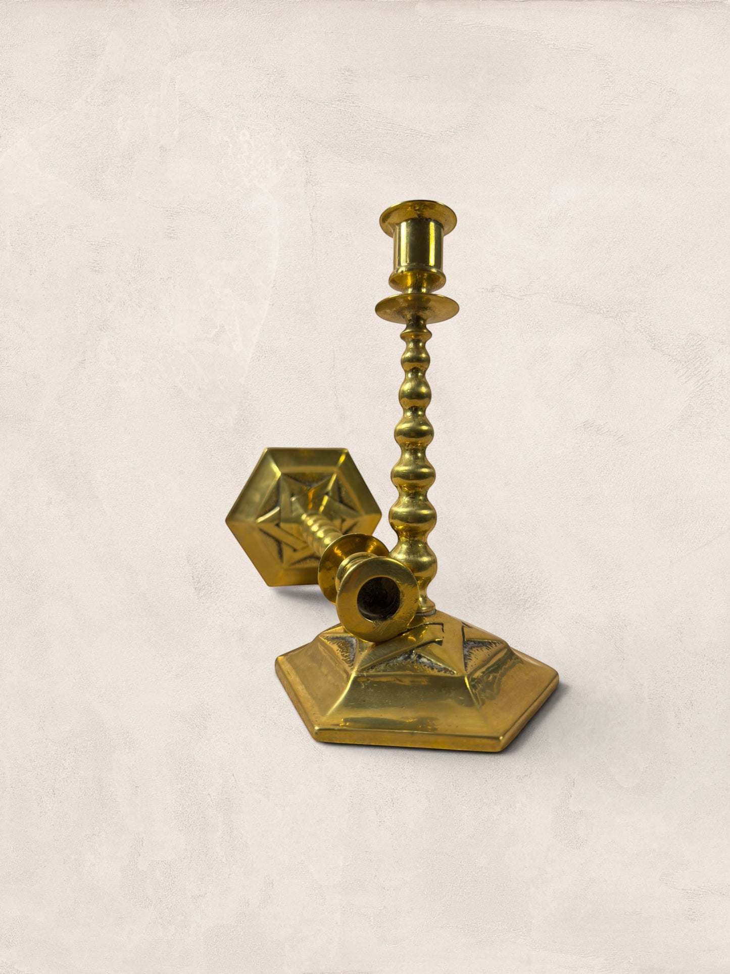 Stone and Relic pair of vintage brass hexagonal base candlesticks with aged patina, circa 1920.