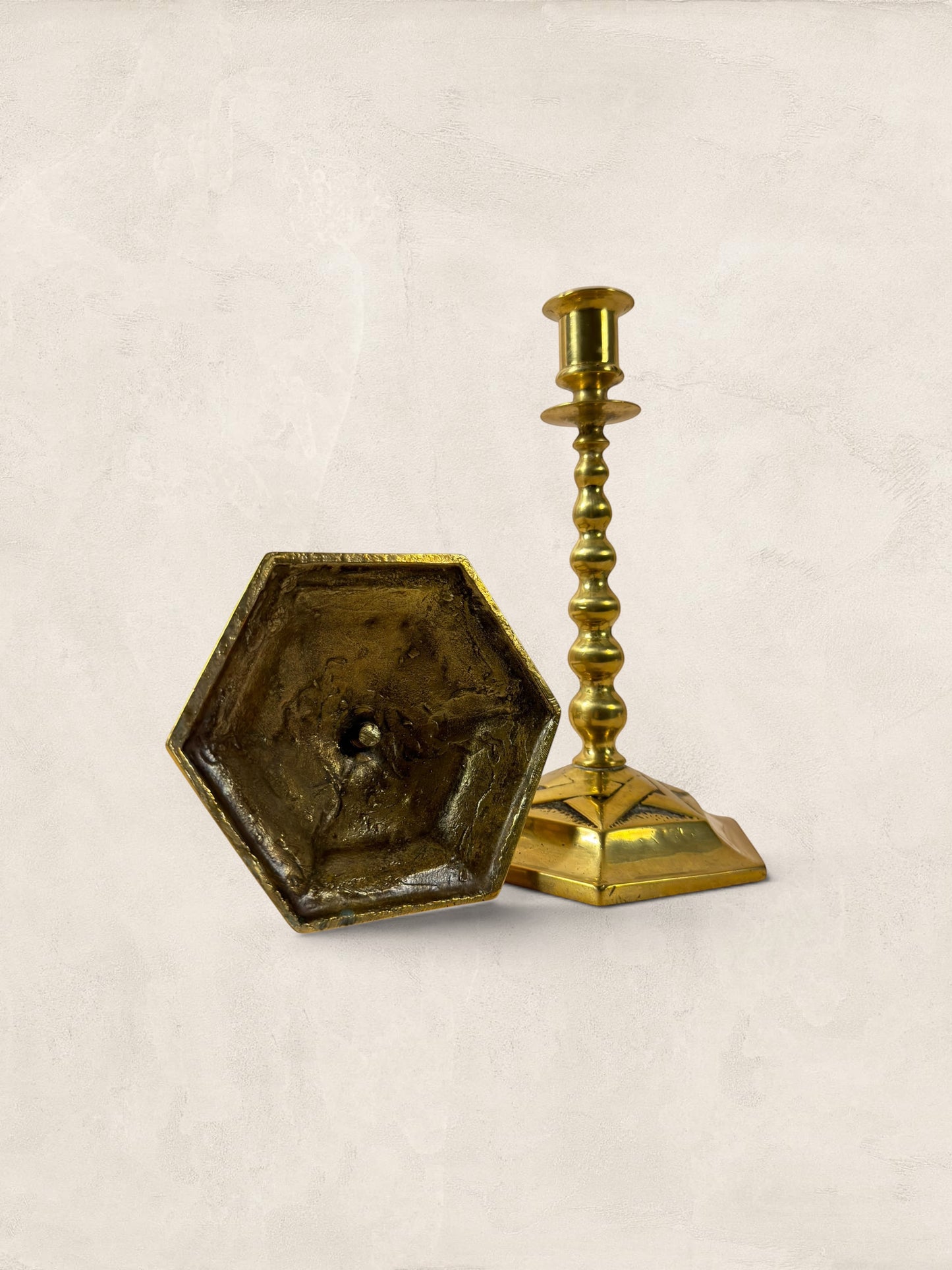 Stone and Relic pair of vintage brass hexagonal base candlesticks with aged patina, circa 1920.