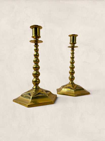 Stone and Relic pair of vintage brass hexagonal base candlesticks with beaded stems and aged patina.