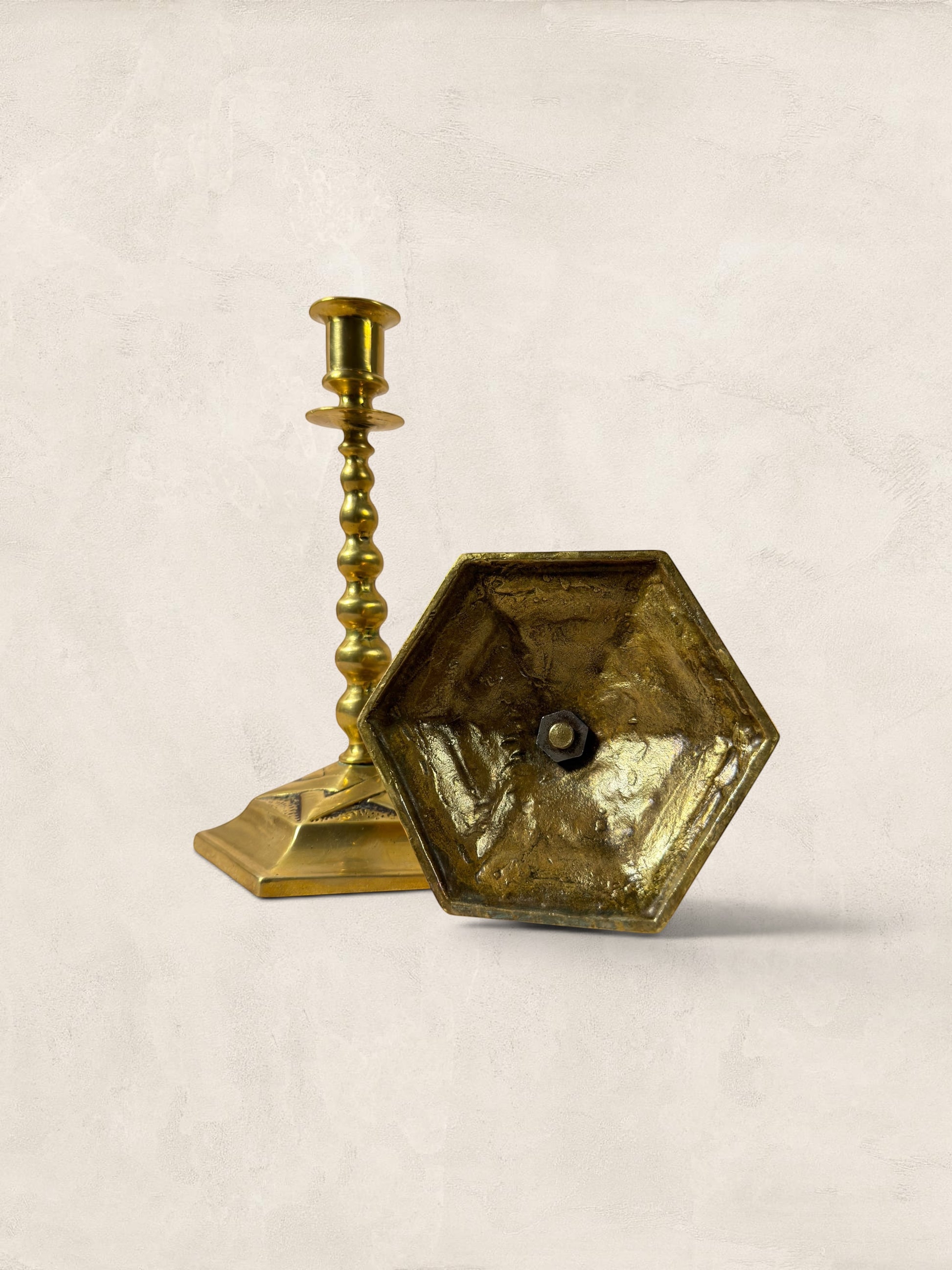 Stone and Relic pair of vintage brass hexagonal base candlesticks with aged patina and beaded stem detail.