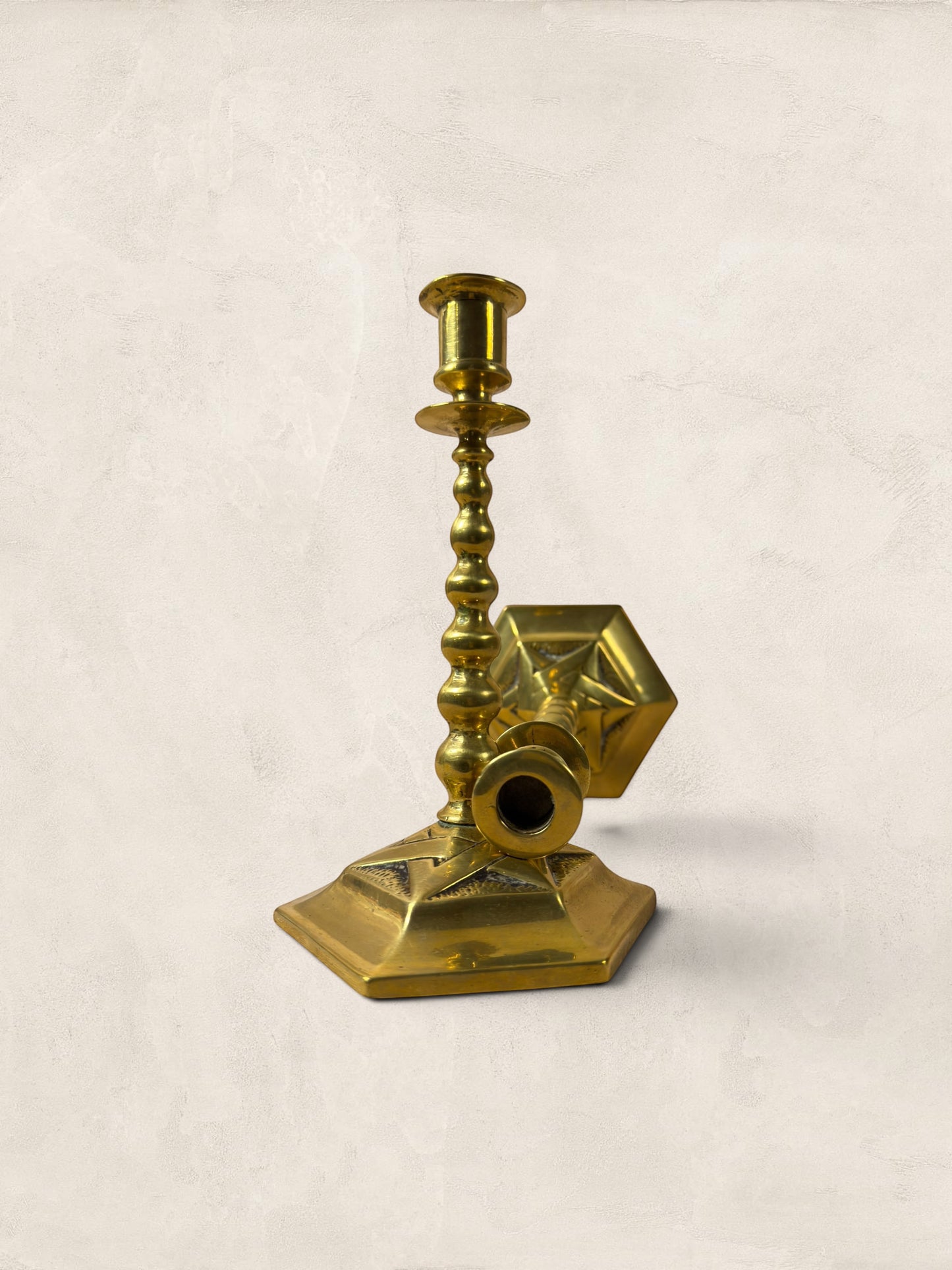 Stone and Relic pair of vintage brass hexagonal base candlesticks with aged patina and beaded stems.