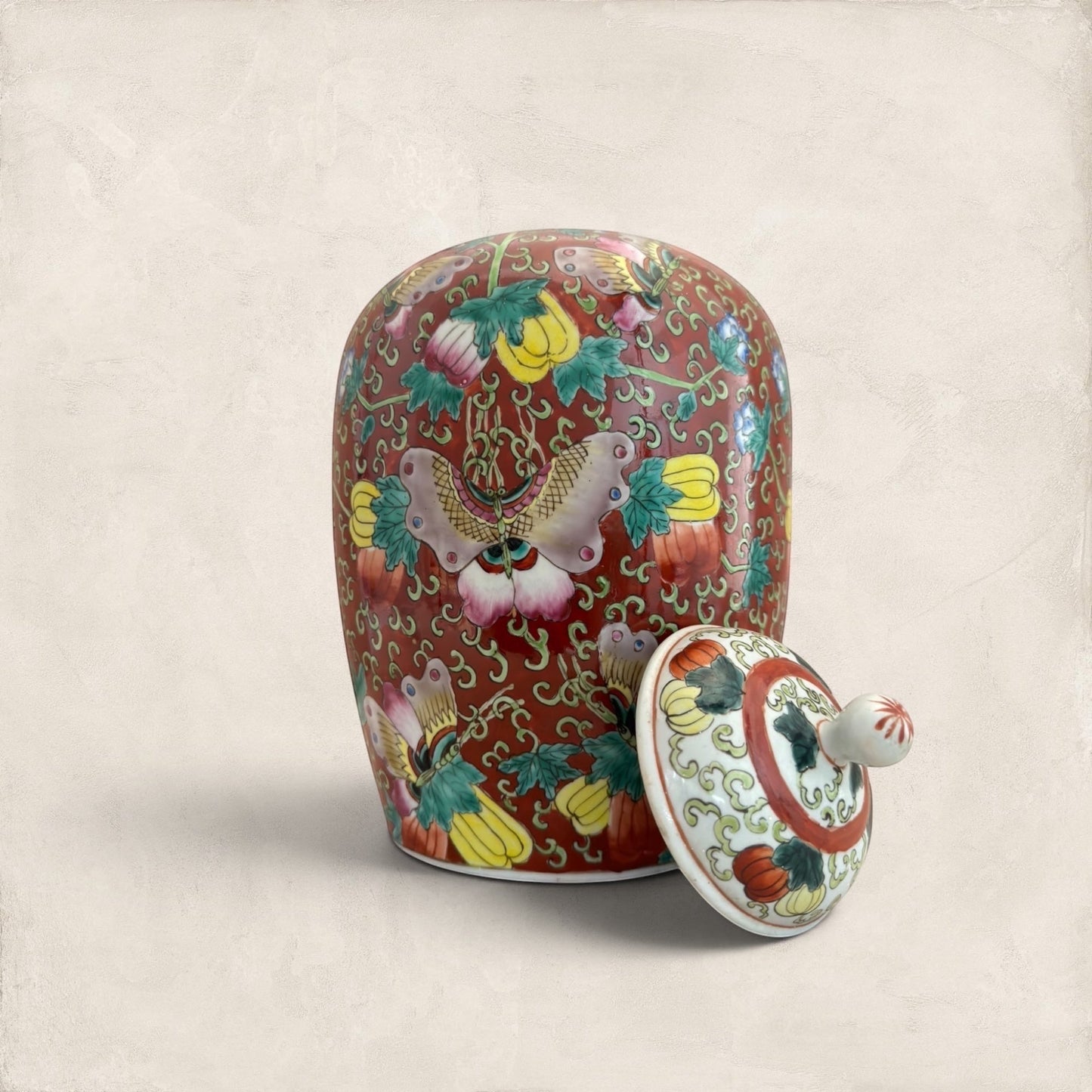 Stone and Relic decorative ceramic ginger jar with butterfly and floral motif in red, yellow, pink, green, and blue.
