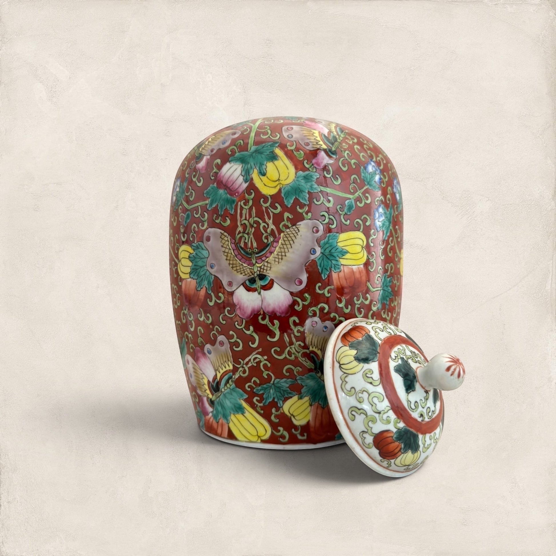 Stone and Relic decorative ceramic ginger jar with butterfly and floral motif in red, yellow, pink, green, and blue.
