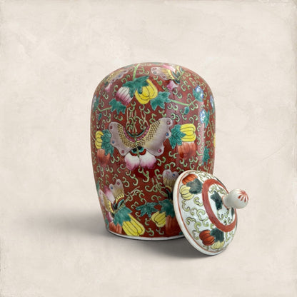 Stone and Relic decorative ceramic ginger jar with butterfly and floral motif in red, yellow, pink, green, and blue.