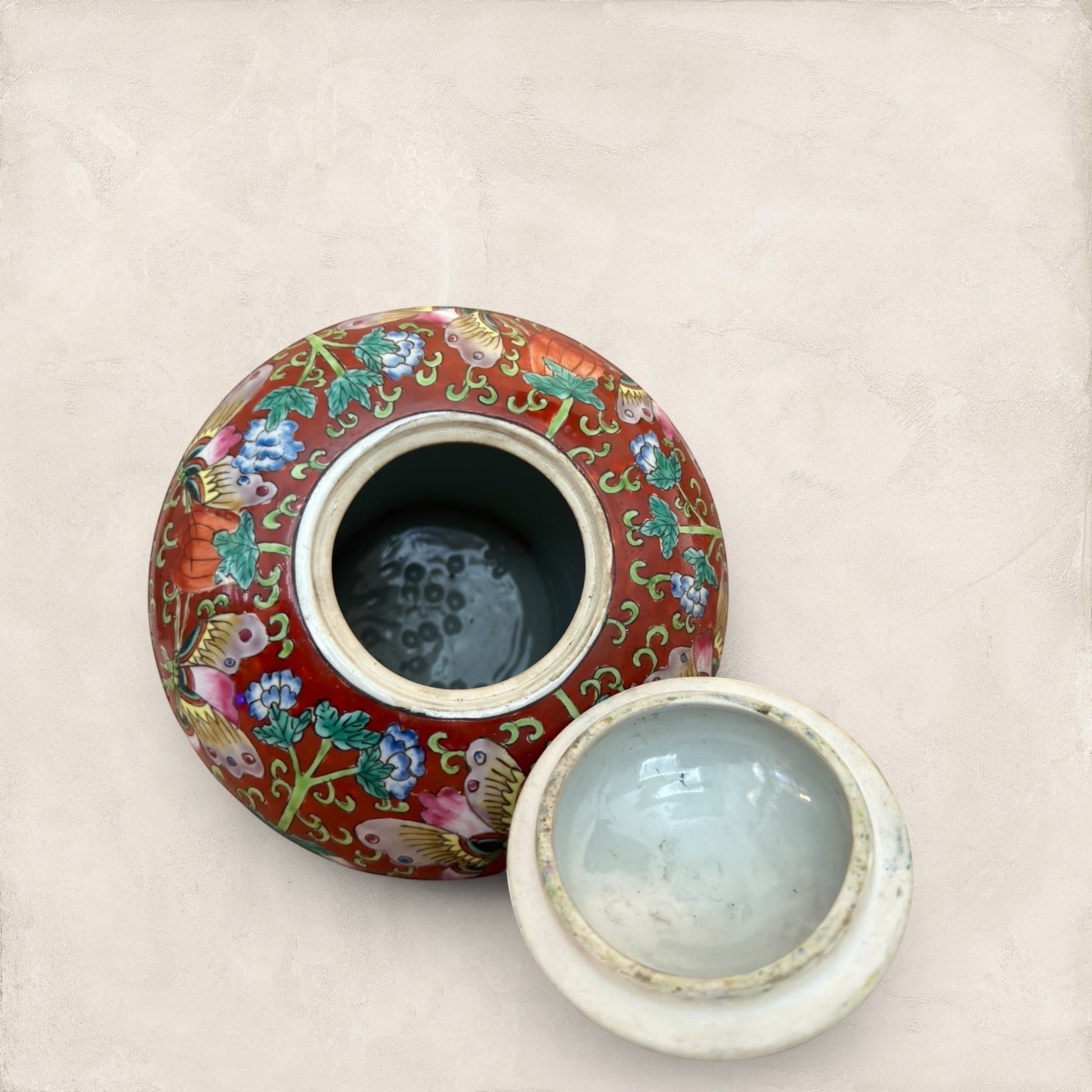 Stone and Relic decorative ceramic ginger jar with butterfly and floral motif in red, yellow, pink, green, and blue.