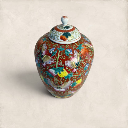 Stone and Relic decorative ceramic ginger jar with butterfly and floral motif in red, yellow, pink, green, and blue.