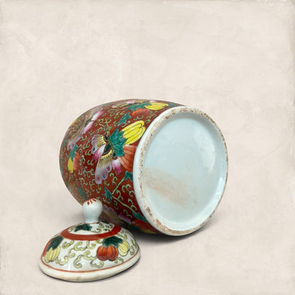 Stone and Relic decorative ceramic ginger jar with butterfly and floral motif in red, yellow, pink, green, and blue.