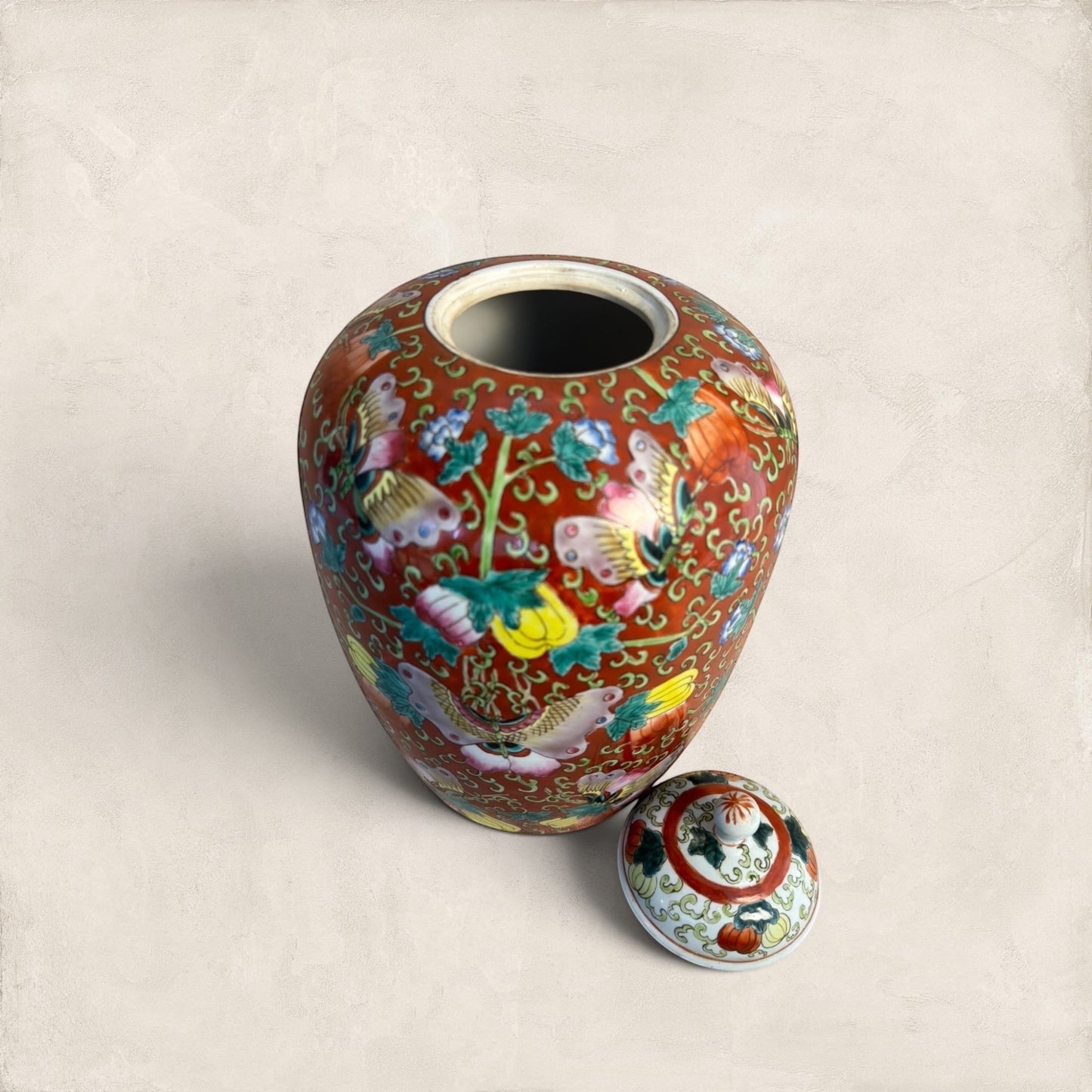 Stone and Relic decorative ceramic ginger jar with butterfly and floral motif in red, yellow, pink, green, and blue.