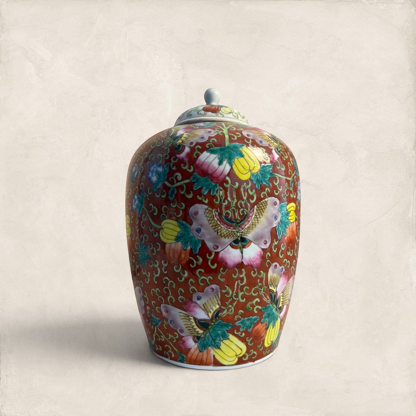 Stone and Relic decorative ceramic ginger jar with butterfly and floral motif in red, yellow, pink, green, and blue.