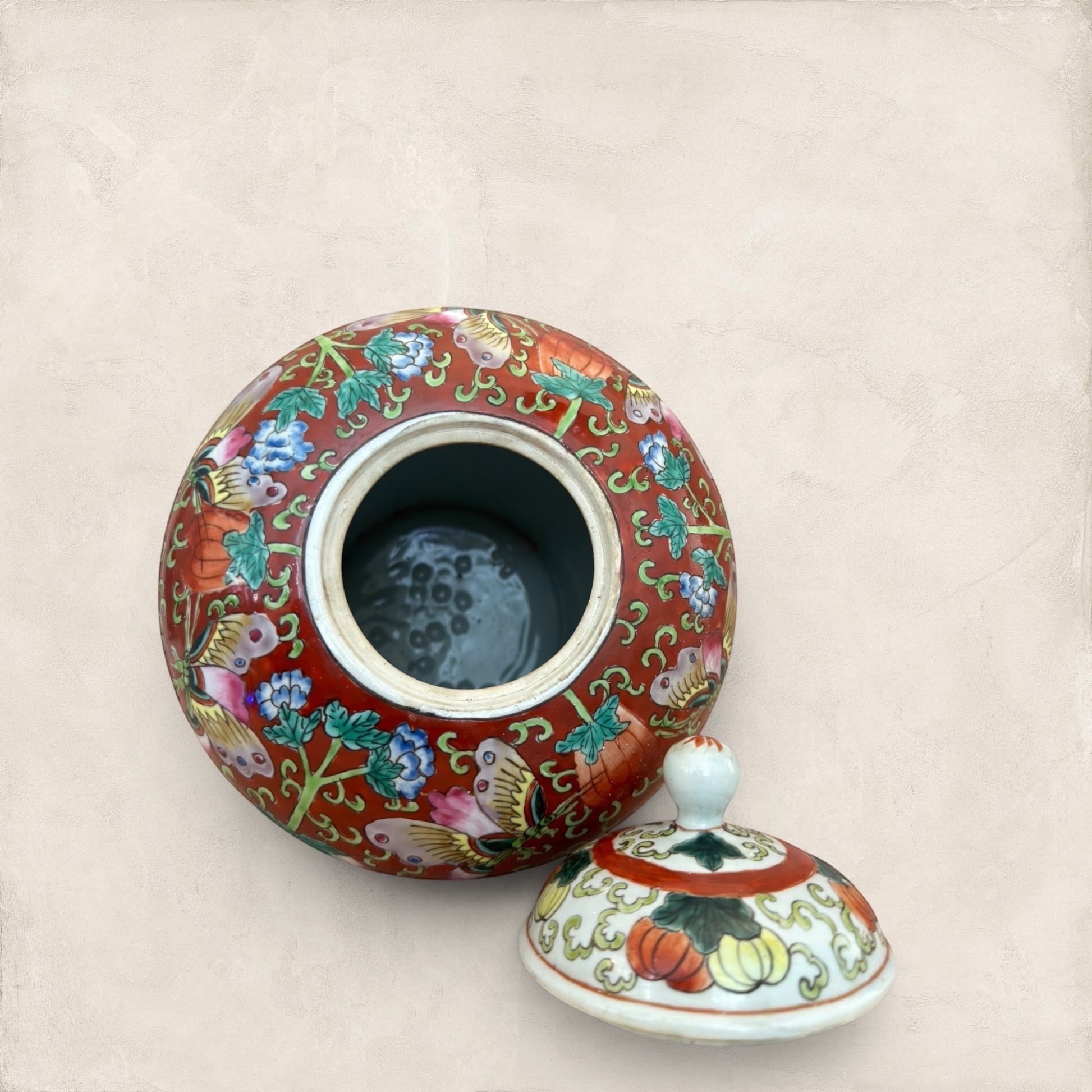 Stone and Relic decorative red ceramic ginger jar with butterfly and floral motif, includes lid.