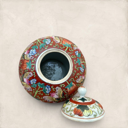 Stone and Relic decorative red ceramic ginger jar with butterfly and floral motif, includes lid.