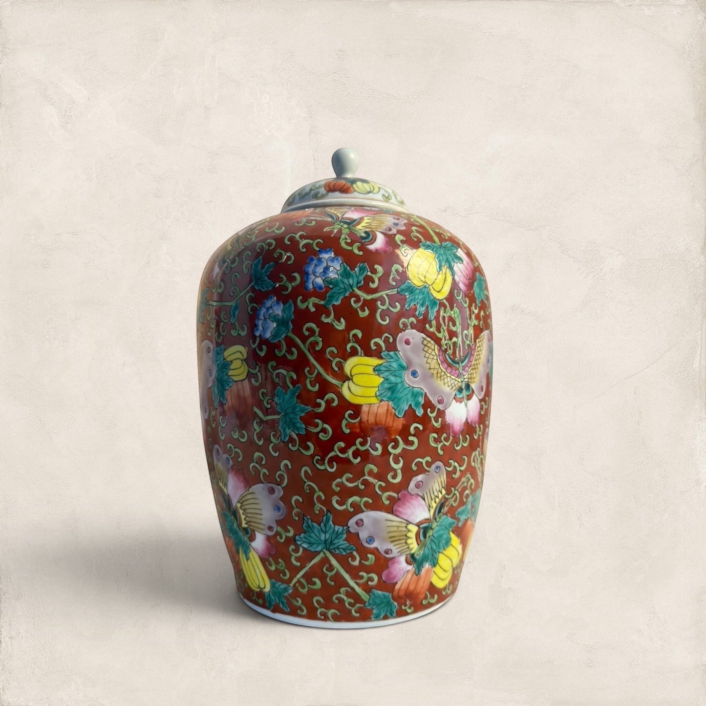 Stone and Relic decorative ceramic ginger jar with butterfly and floral motif in red, yellow, pink, green, and blue.