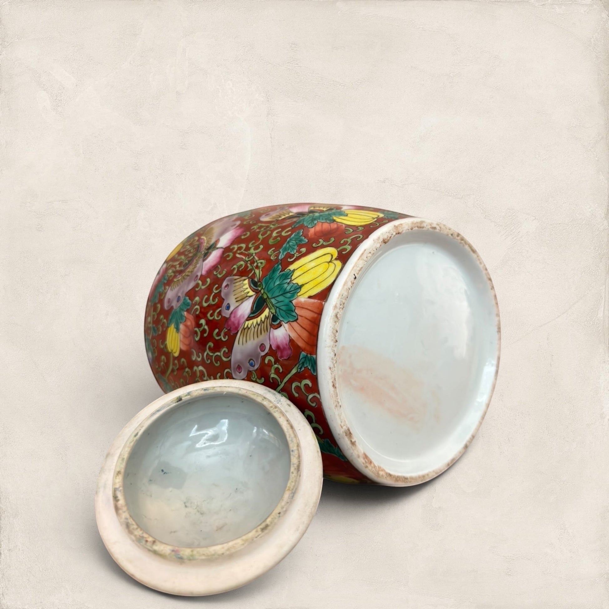 Stone and Relic decorative ceramic ginger jar with butterfly and floral motif in red, yellow, pink, green, and blue.