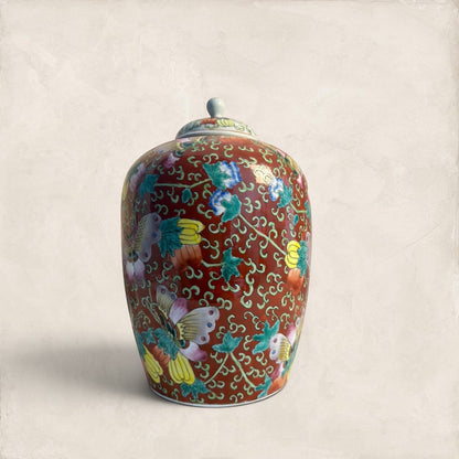 Stone and Relic decorative ceramic ginger jar with butterfly and floral motif in red, yellow, pink, green, and blue.