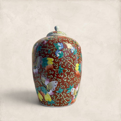 Stone and Relic decorative ceramic ginger jar with butterfly and floral motif in red, yellow, pink, green, and blue.