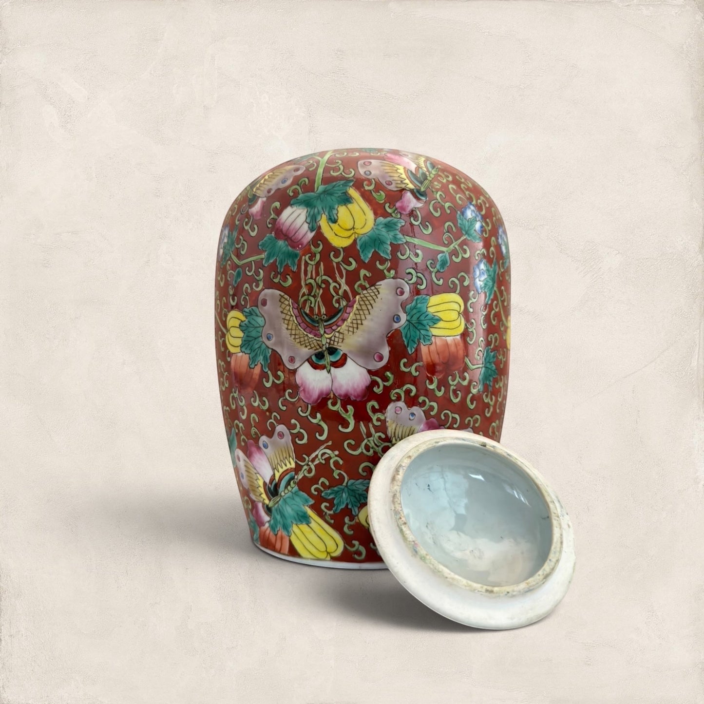 Stone and Relic decorative red ceramic ginger jar with butterfly and floral motif, includes lid.